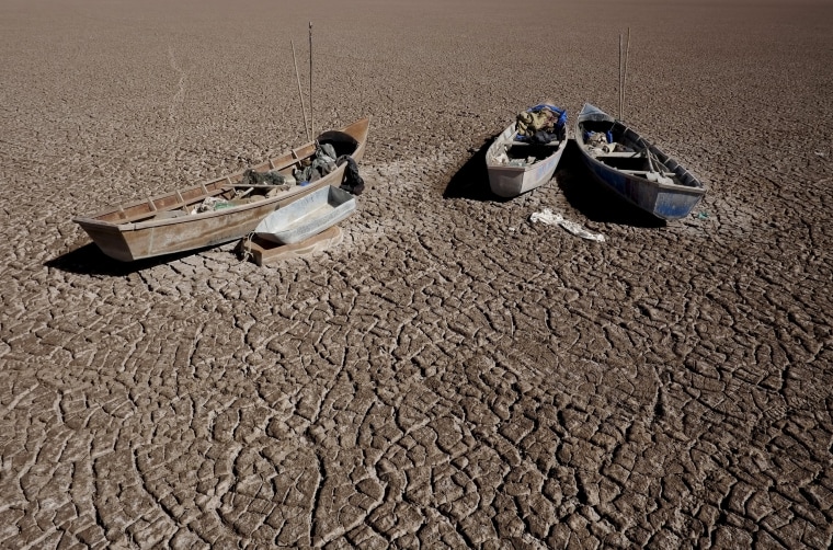 Image: Boats of fishermen are seen on the dried Poopo lakebed in the Oruro Department, south of La Paz