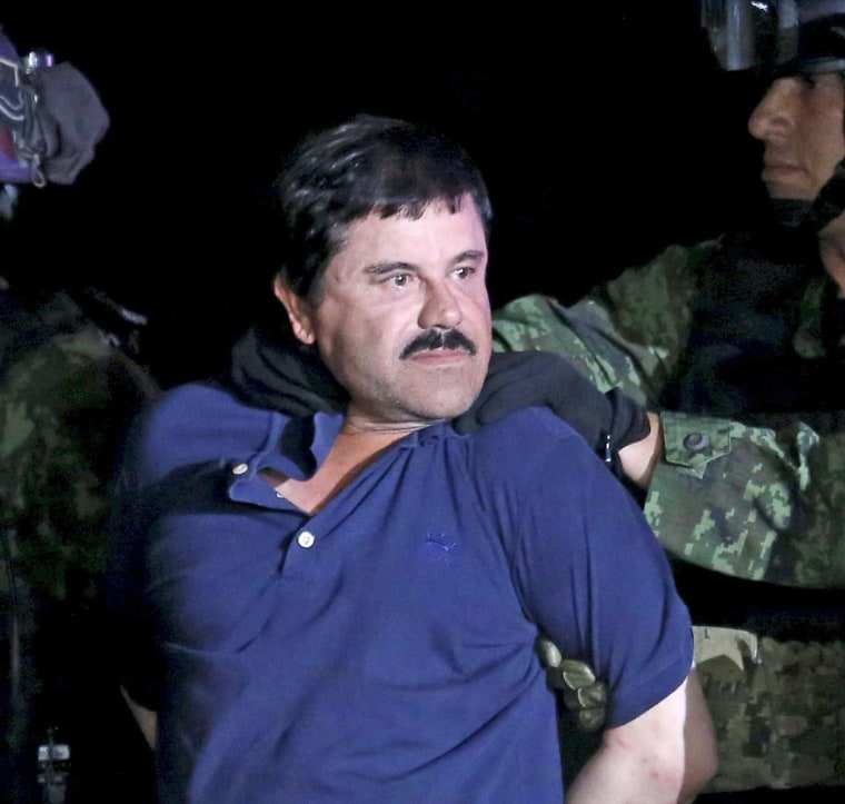Image: Recaptured drug lord Joaquin "El Chapo" Guzman is escorted by soldiers during a presentation in Mexico City