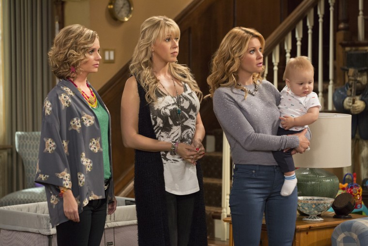 "Fuller House" focuses on D.J. Tanner-Fuller (played by Candace Cameron Bure, holding the baby) asking her sister Stephanie (Jodie Sweetin, center) and friend Kimmy Gibbler (Andrea Barber, left) to help raise D.J.'s three boys.