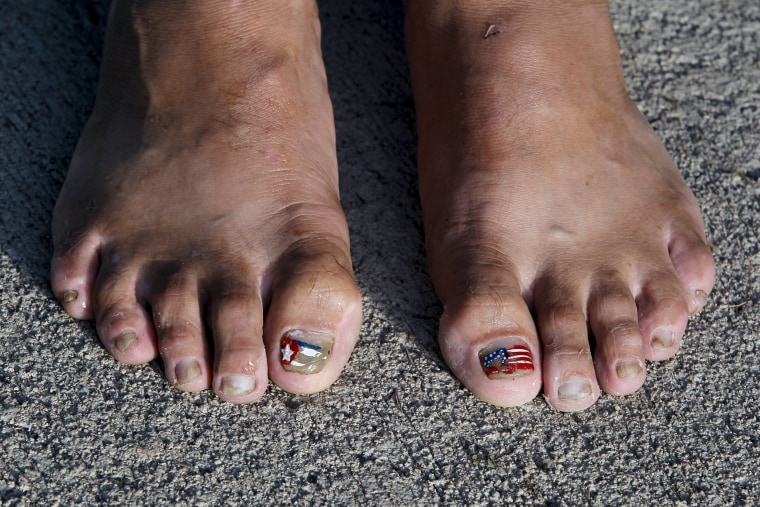 Image: Cuban migrant shows her toes decorated with the flags of Cuba and the United States at a temporary shelter in a school in the town of La Cruz, Costa Rica