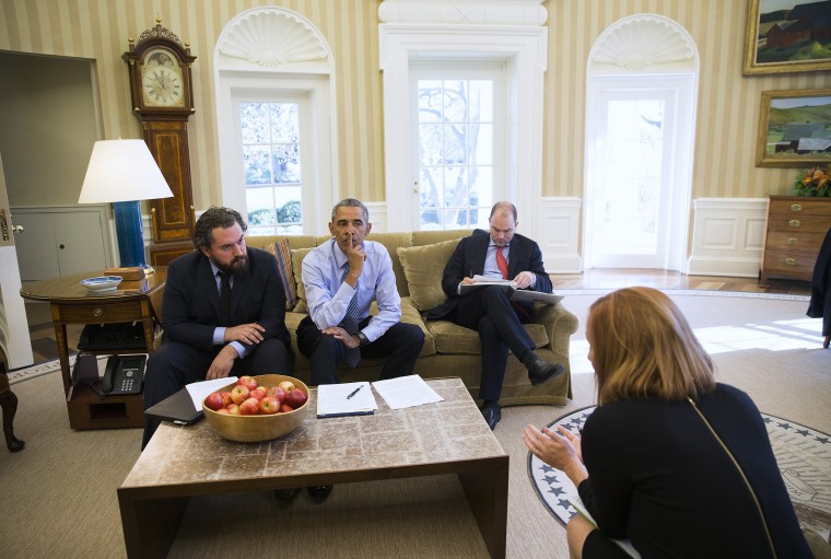 Image: President Barack Obama works with Cody Keenan, left, the president’s director of speechwriting, Ben Rhodes, the deputy national security adviser, and Jen Psaki, foreground, Director of  White House Communications, in the Oval Office of the White