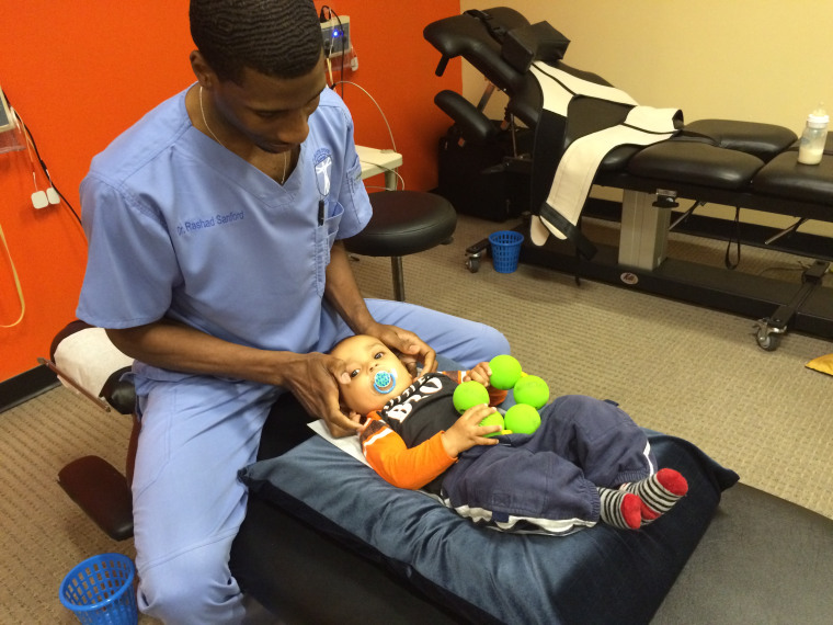 Dr. Rashad Sanford works with a young patient.