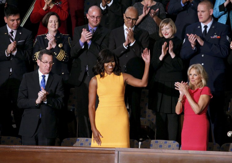 Michelle Obama waves from her box in the gallery while attending U.S. President Barack Obama's State of the Union address to a joint session of Congress in Washington
