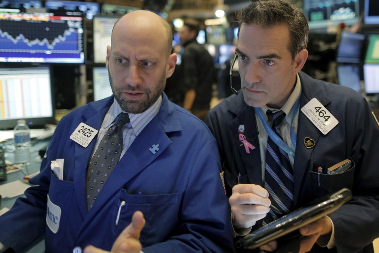 Image: Specialist trader Meric Greenbaum gives a price quote to trader Greg Rowe on the floor of the New York Stock Exchange