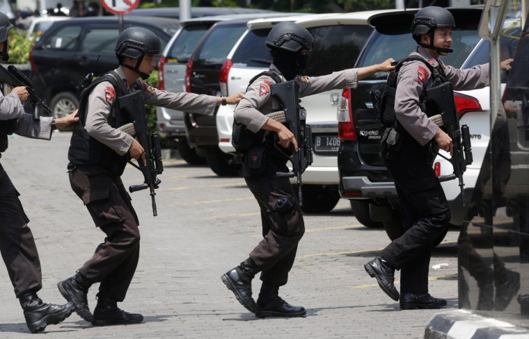 Image: Police officers take position near the site where the explosion went off