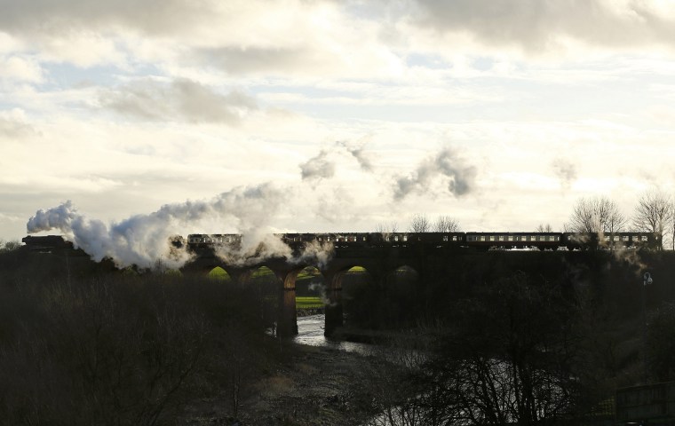 Image: The Flying Scotsman steam engine passes over a viaduct as it leaves East Lancashire Railway in Bury
