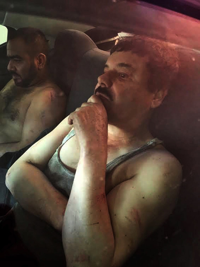 Image: Joaquin \"El Chapo\" Guzman sits in a vehicle after he was recaptured in the city of Los Mochis