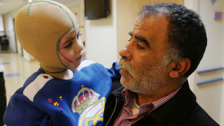 Image: Hossein Dawabsheh holds his 4-year-grandson Ahmad Dawabsheh.