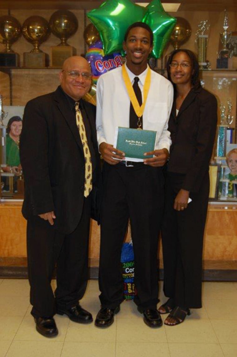 Image: Officer Liquori Tate with his parents after graduation