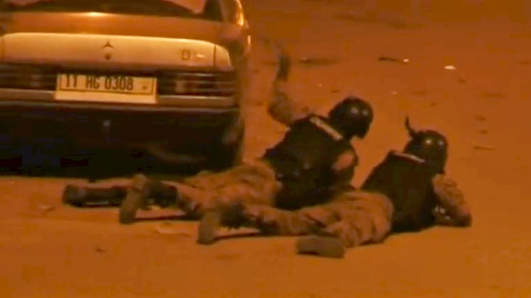 Image: Security officers take their positions outside Splendid Hotel in Ouagadougou