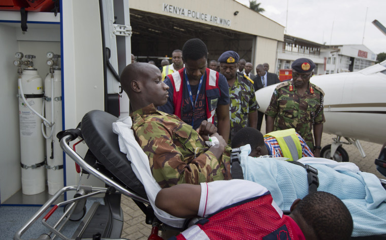 Image: A Kenyan soldier injured in the attack by al-Shabab in Somalia is carried on a stretcher
