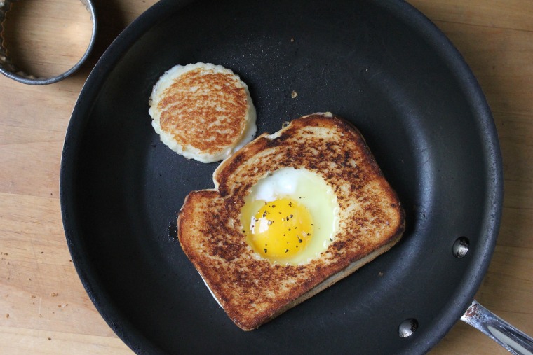 Grilled Cheese Egg-in-a-Hole: Melt 1 teaspoon of butter in the hole. Crack the egg into the hole and sprinkle with salt and pepper.