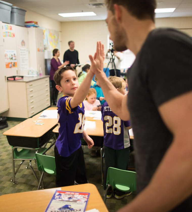 Walsh high-fives a young fan.