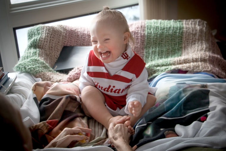 Joey and Indy feek playing on the bed.