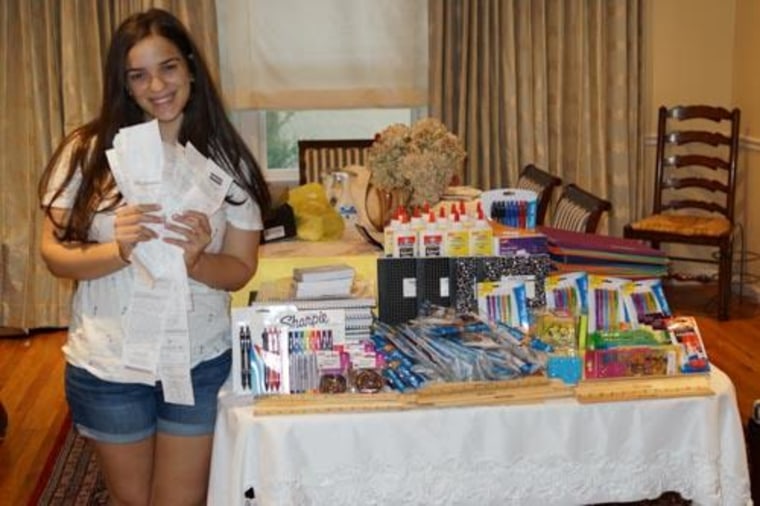 Hannah Steinberg clips coupons to help donate items to charities