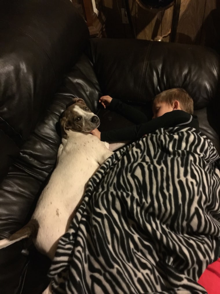 Kahne Williams sleeping with his dog Kase