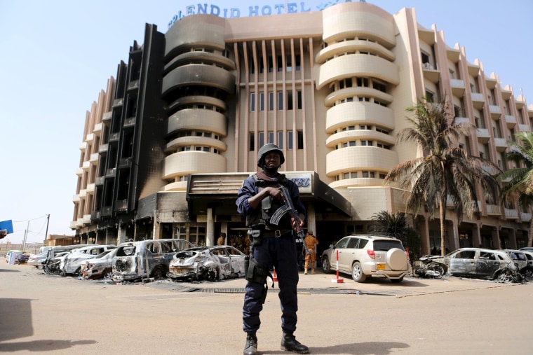 Image: A soldier stands guard in front of Splendid Hotel in Ouagadougou