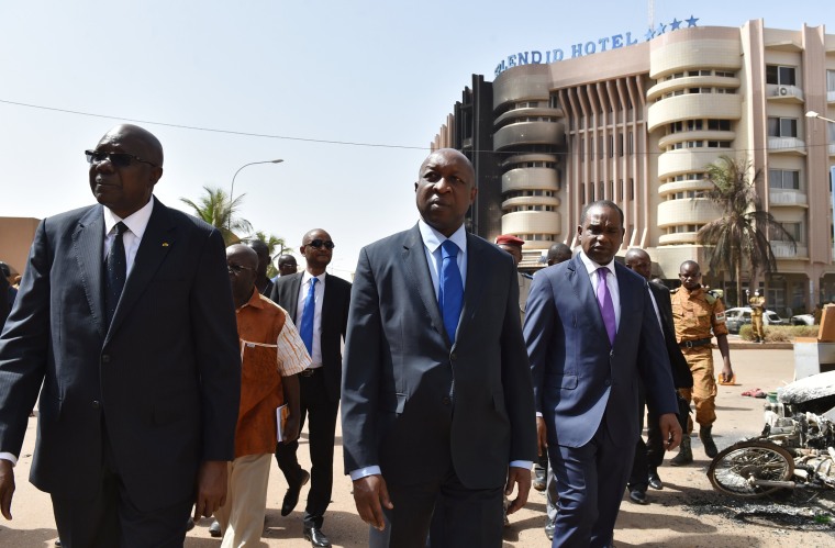 Image: Malian Prime Minister Modibo Keita (L) Burkina Faso's Prime Minister Paul Kaba Thieba (C) and Burkina Faso's foreign Minister Alpha Barry leave after visiting the Splendid hotel