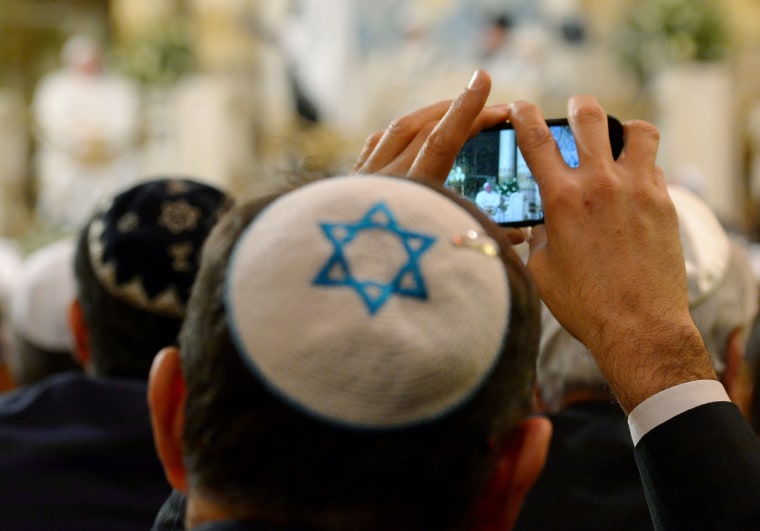Image: A member of the Rome's Jewish community takes photos of Pope Francis