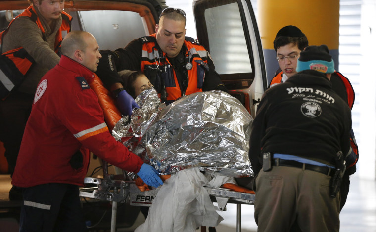 Image: An injured Israeli woman is evacuated