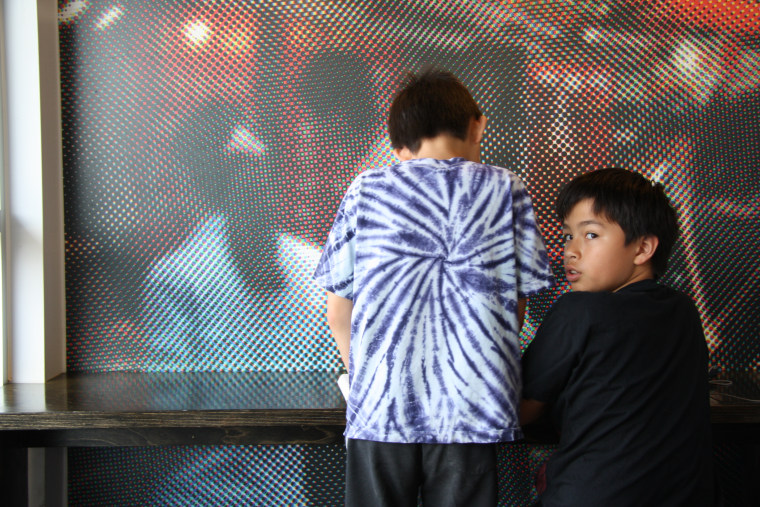 Frances Kai-Hwa Wang’s son (known as Little Brother) introducing “Garfield” to his best friend. This photo, taken by Wang, was originally published by the Smithsonian Asian Pacific American Center.