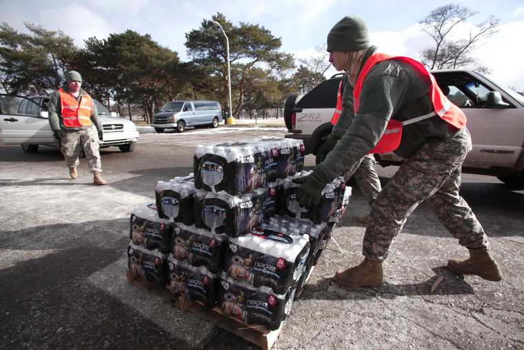 Image: Soldiers from the Michigan Army National Guard Flint prepare to give Flint residents bottled water