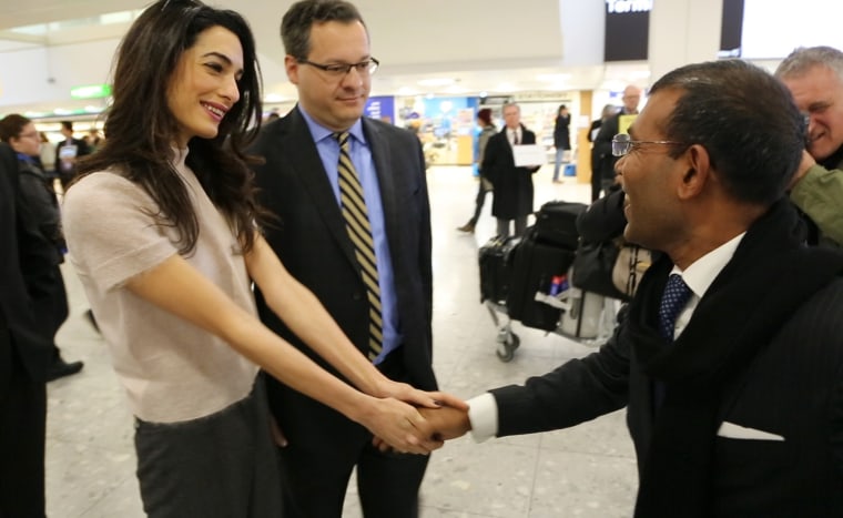 Image: Former Maldives President Nasheed Mohamed is greeted by his attorneys, Amal Clooney and Jared Gender