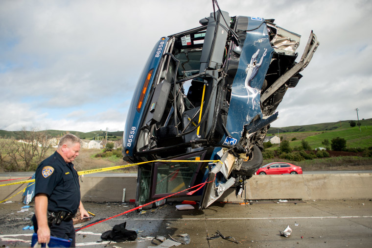 Image: A California Highway Patrol officer moves belongings from a Greyhound bus crash that left two dead