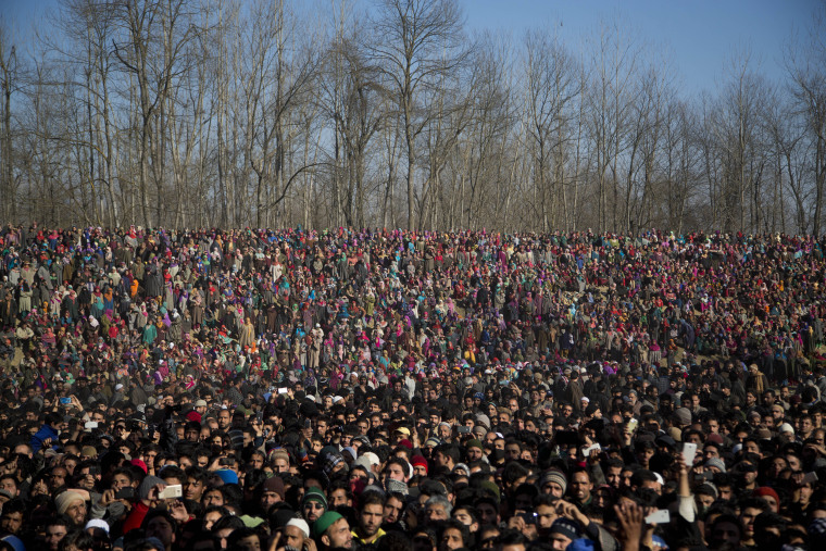 Image: Kashmiri Muslims watch the funeral procession of Shariq Ahmad Bhat