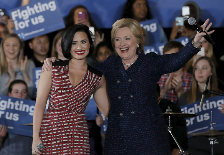 Image: U.S. Democratic presidential candidate Hillary Clinton is joined by singer Demi Lovato at a campaign event in Iowa City