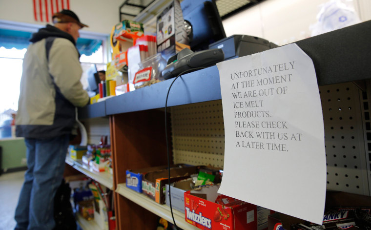 Image: A sign notifies customers of a temporary shortage of ice melts products at a hardware store
