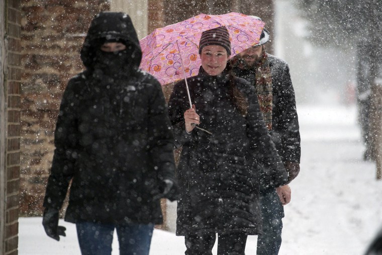 Image: People make their way down Main Street in Lynchburg, Va.