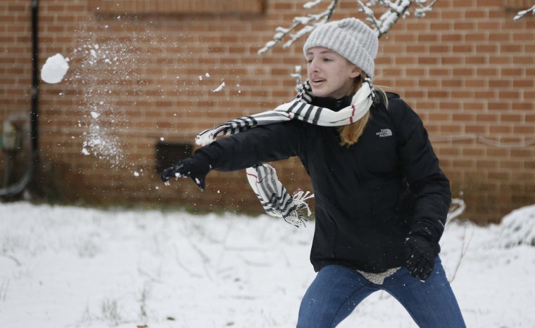 Image: A girl throws a snowball during a neighborhood snowball fight in Oxford, Miss.