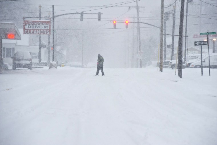 Image: A person walks through the blowing snow in Bowling Green, Ky.