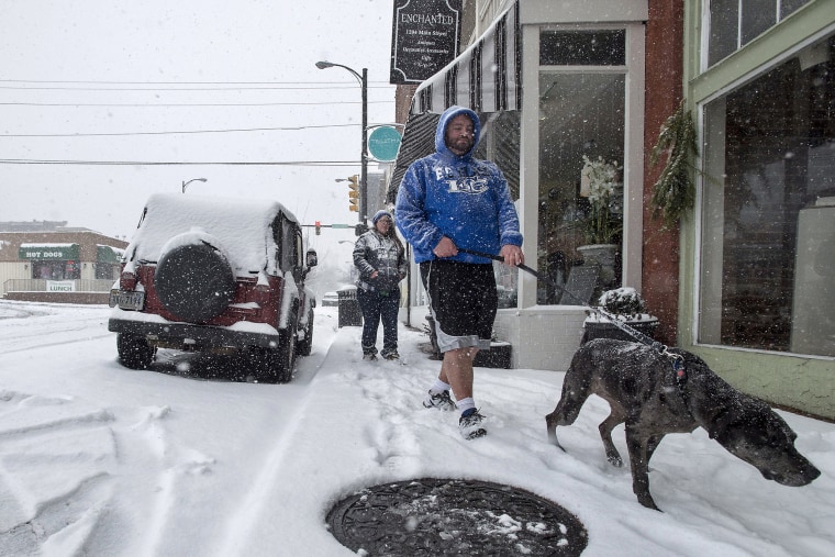 Image: A man walks his dog in Lynchburg, Va.