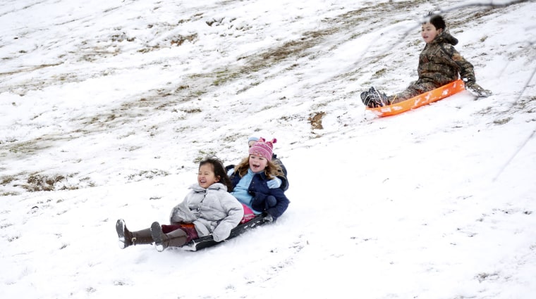 Image: Children sled down the hills in Avent Park