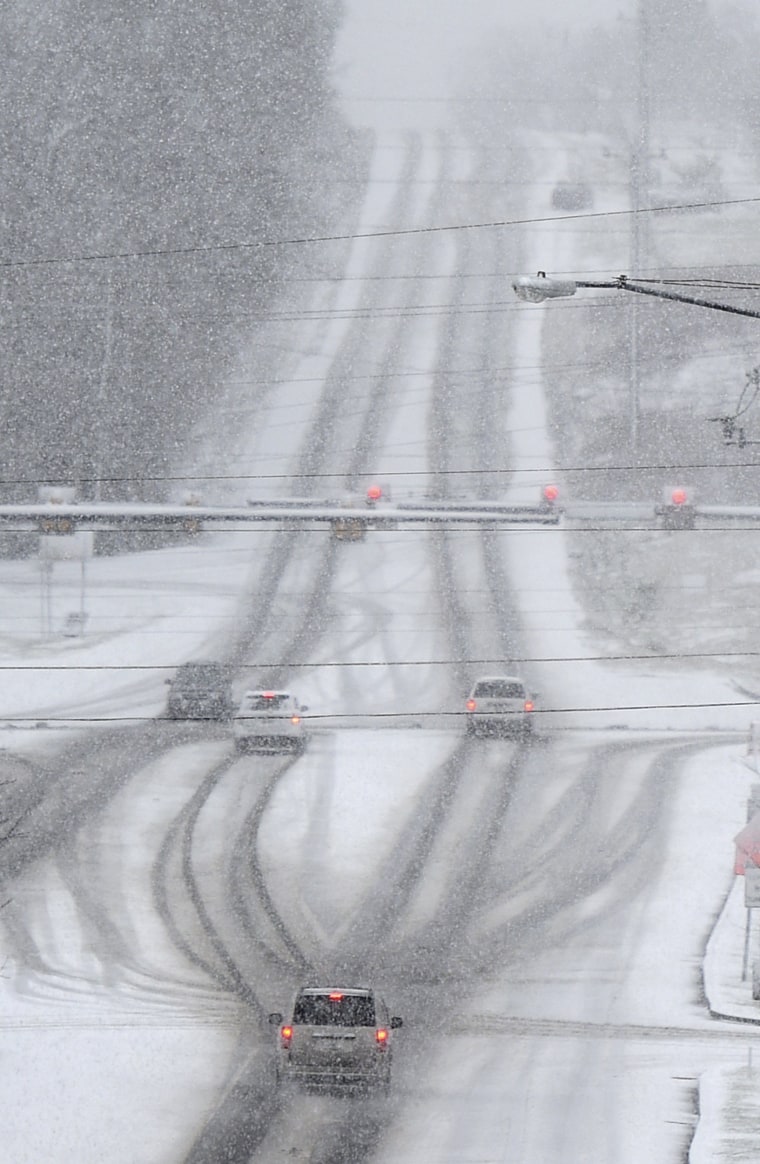 Image: Drivers make their way through falling snow in Franklin, Tenn.