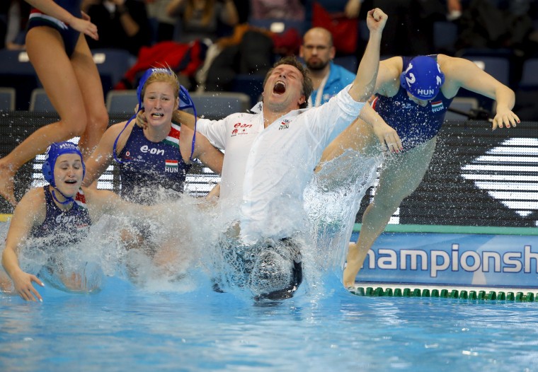 Image: Hungary's coach Attila Biro jumps in the pool as he celebrates his team's victory over Netherlands during the women's European Water Polo Championship gold medallion match in Belgrade