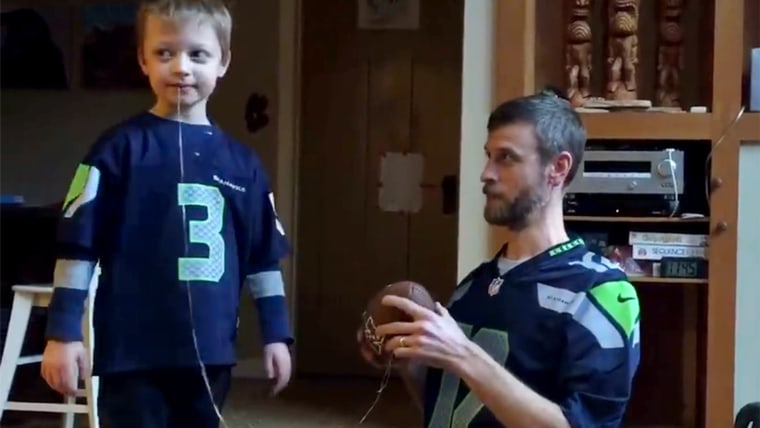 Dad uses football to extract son's loose tooth.