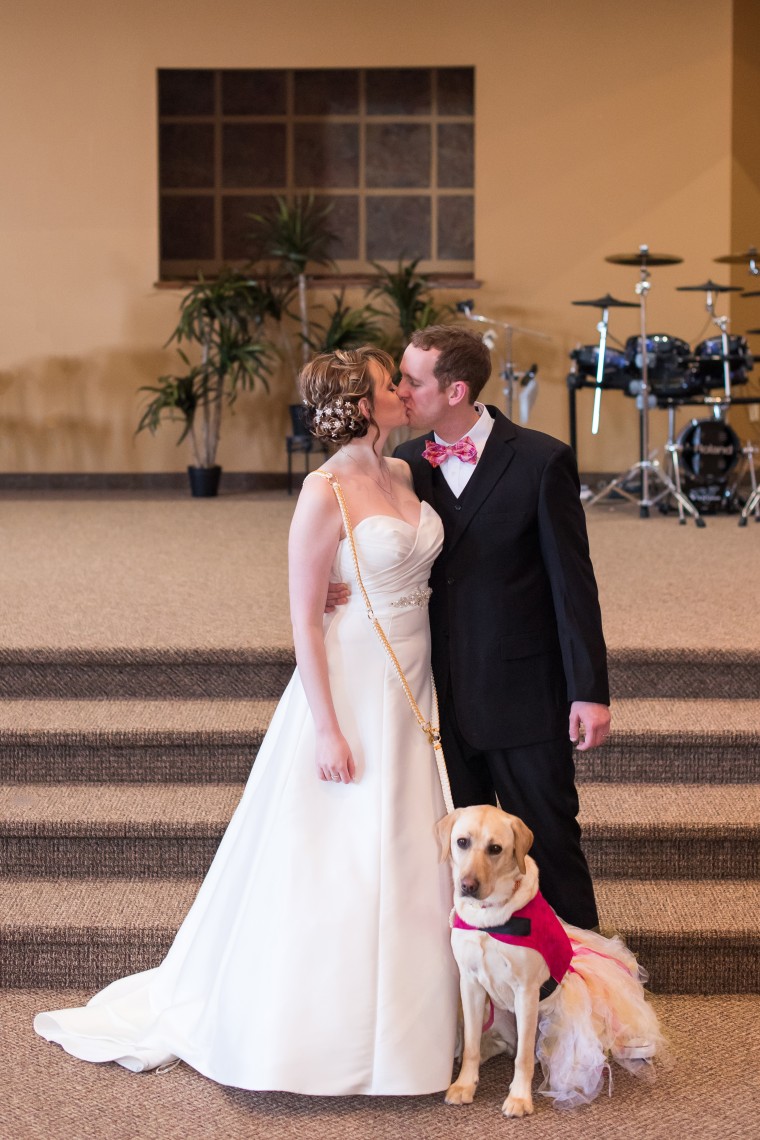 Heartwarming photo shows service dog calming bride before wedding