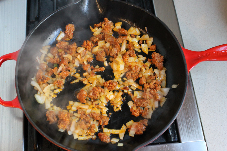Slow Cooker Huevos Rancheros: Cook the sausage and onions