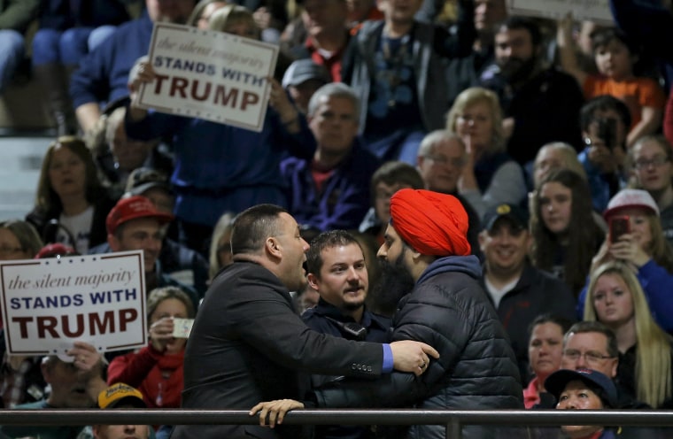 Image: A protester is escorted out of a U.S. Republican presidential candidate Donald Trump campaign event in Muscatine