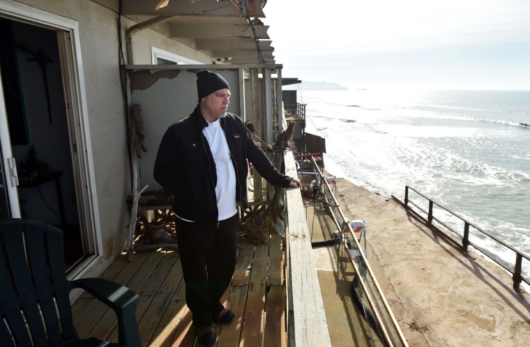 Image: Resident Jonathan Levin surveys missing land from his balcony