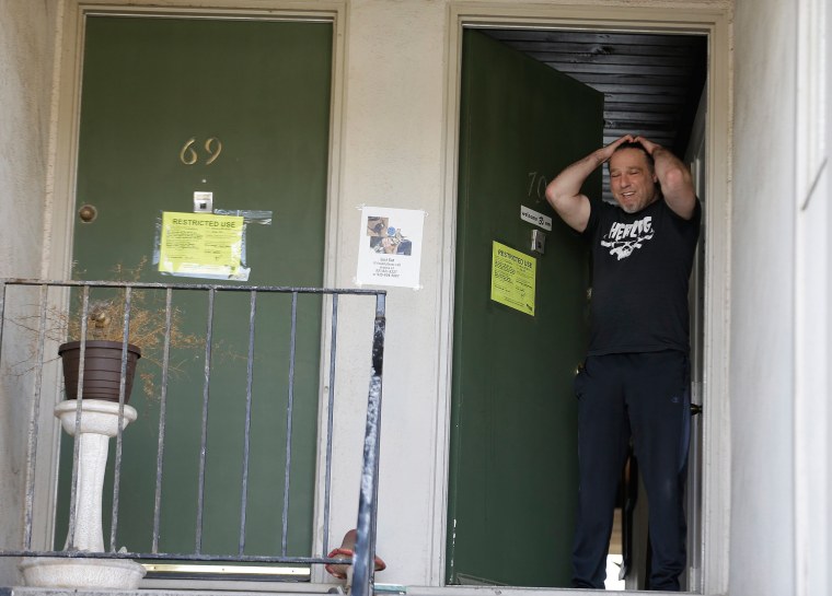 Image: Jonathan Levine stands in his doorway after learning he would have to evacuate his oceanside apartment