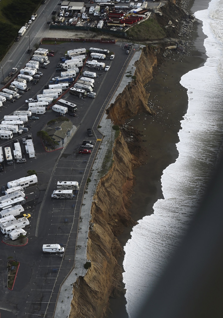 Image: Waves lap at an eroding bluff at the San Francisco RV Resort in Pacifica