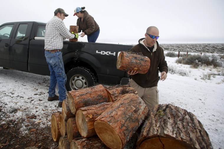 Image: Occupier Ritzheimer help supporters Joe and Amanda Rigney unload firewood at the Malheur National Wildlife Refuge near Burns