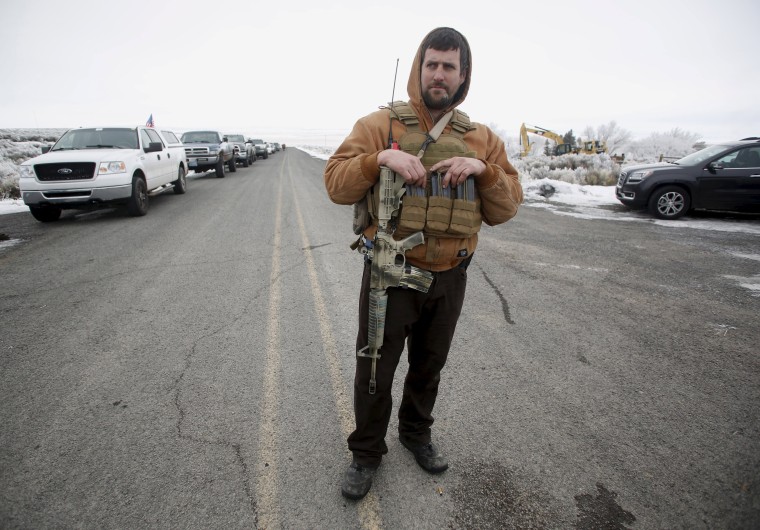 Image: A member of the Pacific Patriots Network looks on while a meeting takes place at the Malheur National Wildlife Refuge near Burns, Oregon