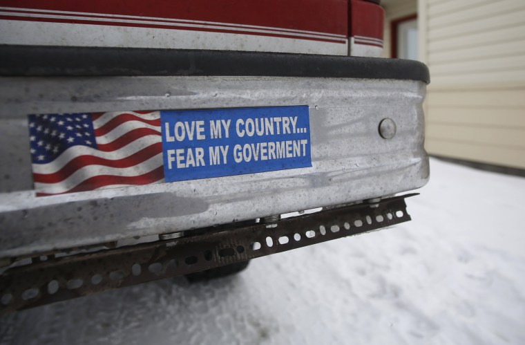 Image: A bumper sticker on a private truck is seen in front of a residential building at the Malheur National Wildlife Refuge near Burns, Oregon