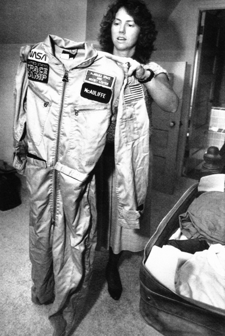 Image: High-school teacher Christa McAuliffe folds her training uniform