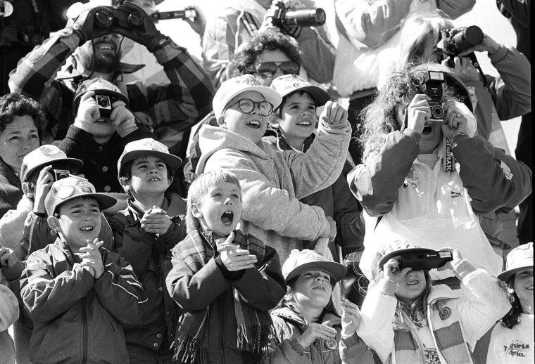 Image: Classmates of the son of America's first teacher-astronaut cheer as the space shuttle Challenger lifts skyward